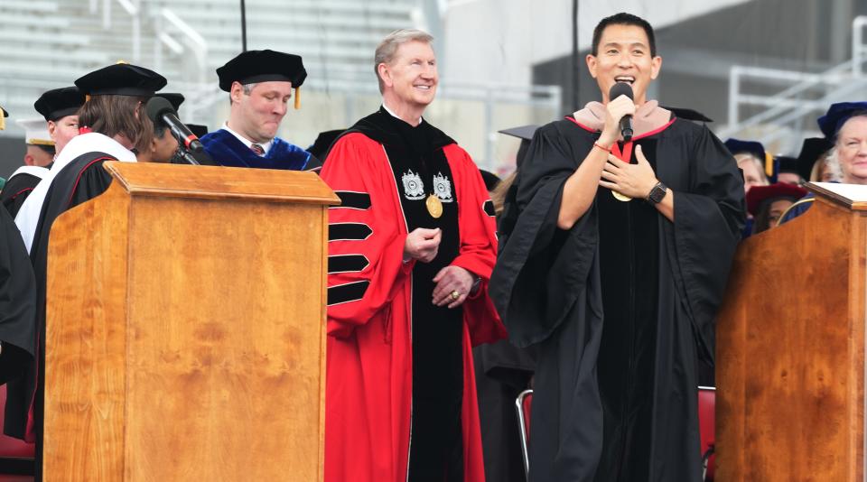 May 5, 2024; Columbus, Ohio, USA; Commencement speaker Chris Pan accepts speaks as Ohio State University President Ted Carter seems to enjoy the speech during the Ohio State Spring 2024 Commencement held Sunday, May 5, 2024 in Ohio Stadium.