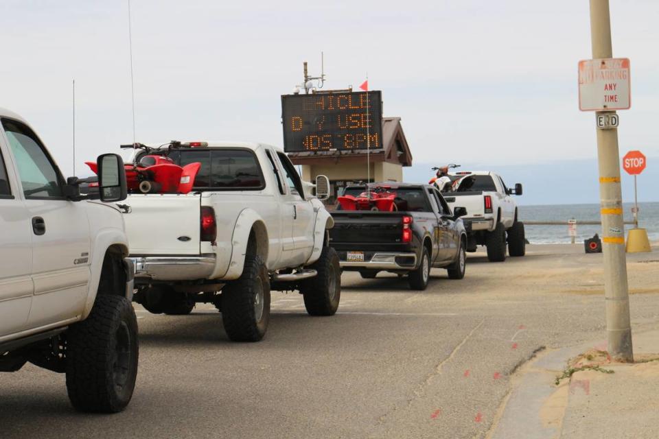 Trucks carrying ATVs line up at the Pier Avenue entrance to Oceano Dunes SVRA on Sunday, March 14.