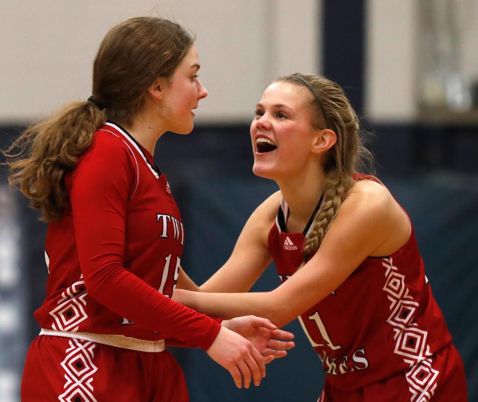 Twin Lakes guard Olivia Nickerson (15) and Twin Lakes guard Addie Bowsman (11) celebrate during the IHSAA girl’s basketball game against the Central Catholic, Thursday, Jan. 5, 2023, at Central Catholic High School in Lafayette, Ind. Twin Lakes won 50-48 in overtime. 