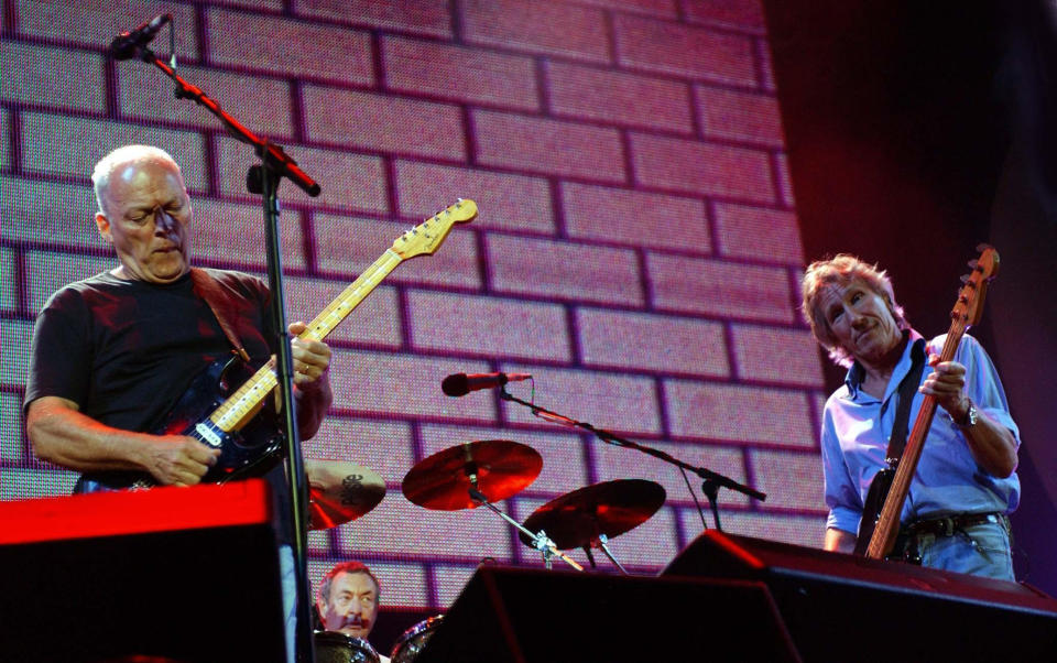 Left to right: Dave Gilmour, Nick Mason and Roger Waters of Pink Floyd performing on stage.