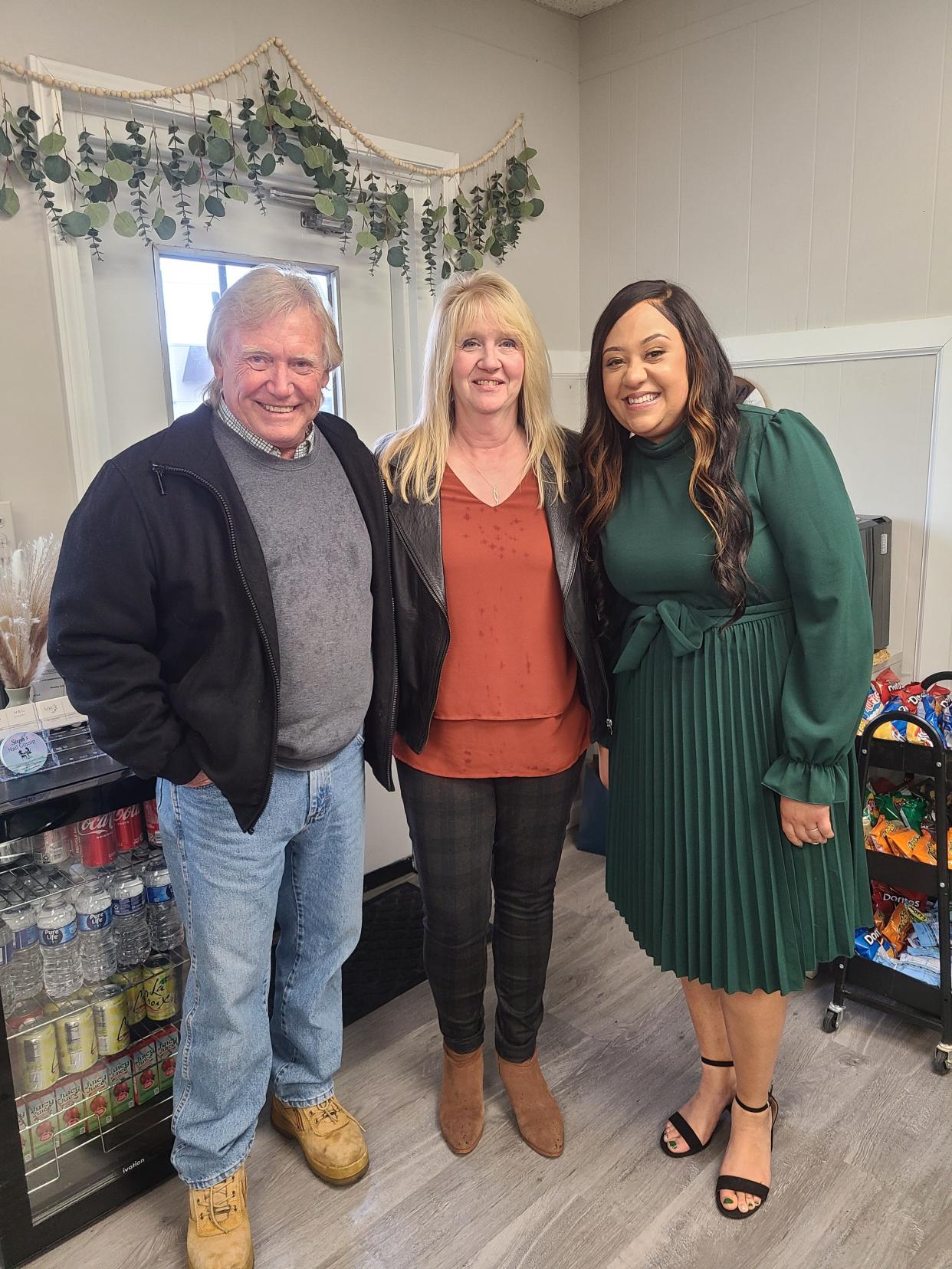 Sandusky County Commissioner Charlie Schwochow, left,  stands with Brenda Ginnever, from the  Sandusky County Chamber of Commerce, center, and and Stacy Root, owner of MRG Beauty Bar.