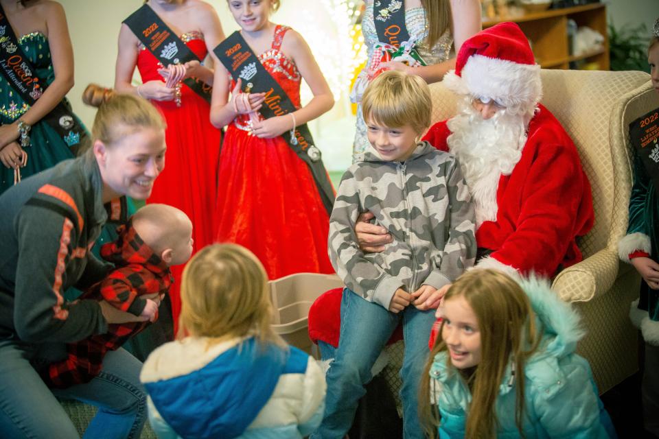 Santa Claus meets with children following the 2022 Christmas Parade held by the West Lafayette Chamber of Commerce.