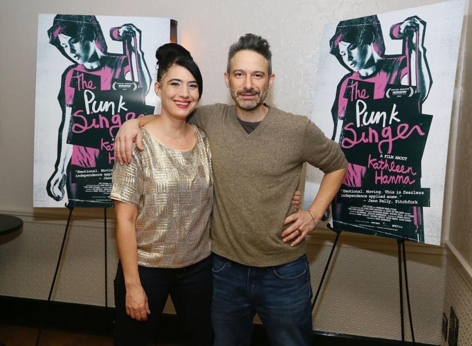 Kathleen Hanna and Adam Horovitz hug and pose for a photo.