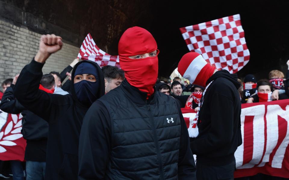 The Ashburton Army, fans of Arsenal, take part in a fan march