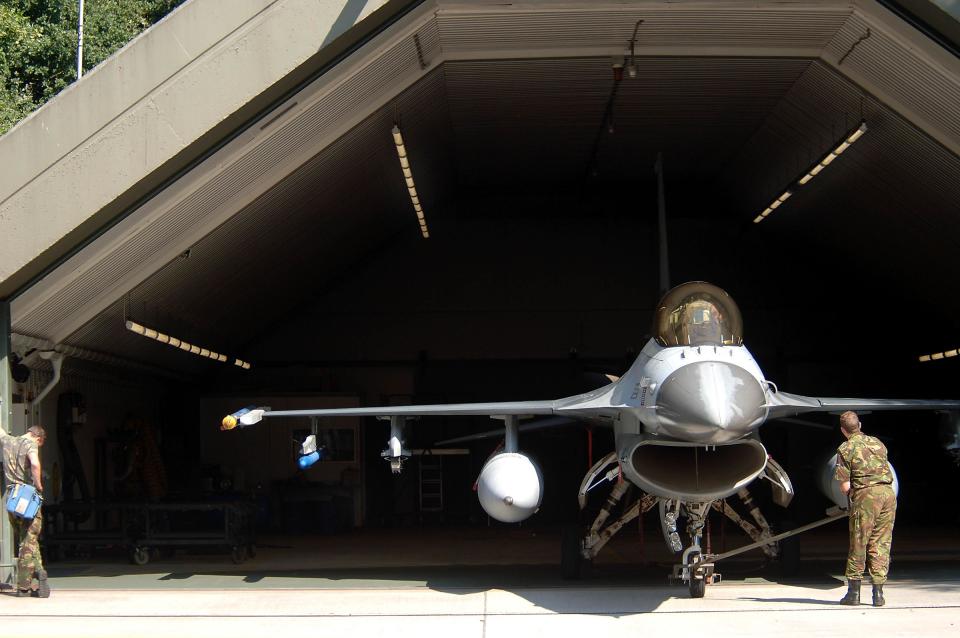 A Dutch F-16 Fighting Falcon is towed into a hardened aircraft shelter at Volkel Air Base. <em>U.S. Air Force photo by Senior Master Sgt. Keith Reed</em>