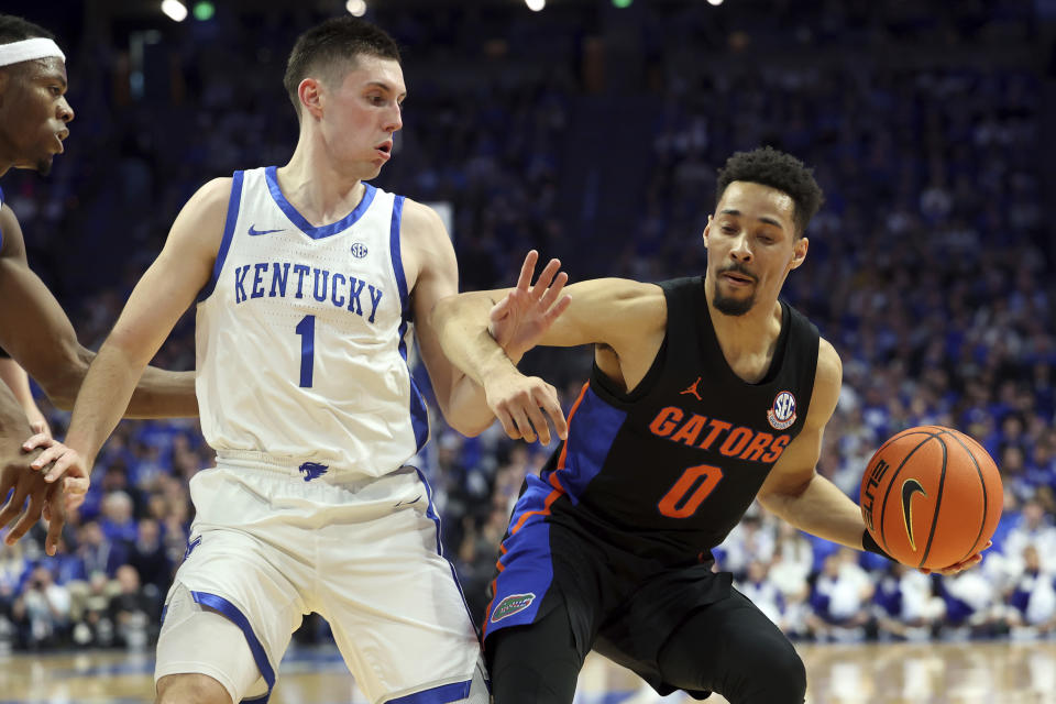 Florida's Myreon Jones (0) is pressured by Kentucky's CJ Fredrick (1) during the second half of an NCAA college basketball game in Lexington, Ky., Saturday, Feb. 4, 2023 (AP Photo/James Crisp)