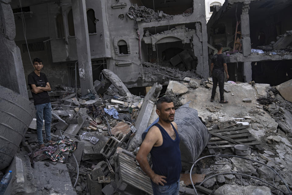Palestinians look for survivors in a building destroyed in Israeli bombardment in Rafah refugee camp in Gaza Strip on Tuesday, Oct. 17, 2023. (AP Photo/Fatima Shbair)