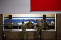 U.S. Army soldiers talk at a concession stand that turned into a pharmacy at a military field hospital for non-coronavirus patients inside CenturyLink Field Event Center during the coronavirus disease (COVID-19) outbreak in Seattle