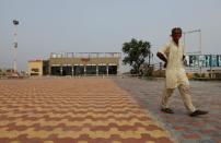 A man walks in front of a temporarily closed restaurant along a national highway in Murthal