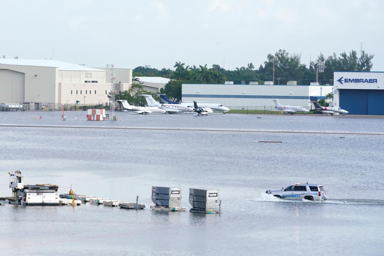 A car drives through flooding at Fort Lauderdale's airport in Florida.