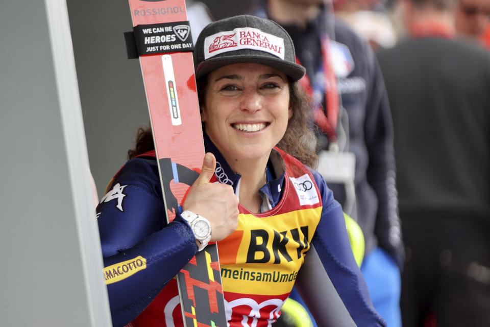 FILE -- In this Feb. 23, 2020 file photo, Italy's Federica Brignone smiles after completing an alpine ski, women's World Cup alpine combined, in Crans Montana, Switzerland. Amid a worldwide suspension of sports events, Brignone was awaiting a special delivery which arrived last month, with three crystal globes: the big 9-kilogram (20-pound) prize for her first overall World Cup triumph — she’s the first Italian woman to win the coveted honor in the 53-year history of the competition -- plus two smaller 3.5-kilogram (8-pound) globes for her season-long giant slalom and Alpine combined titles. (AP Photo/Alessandro Trovati)