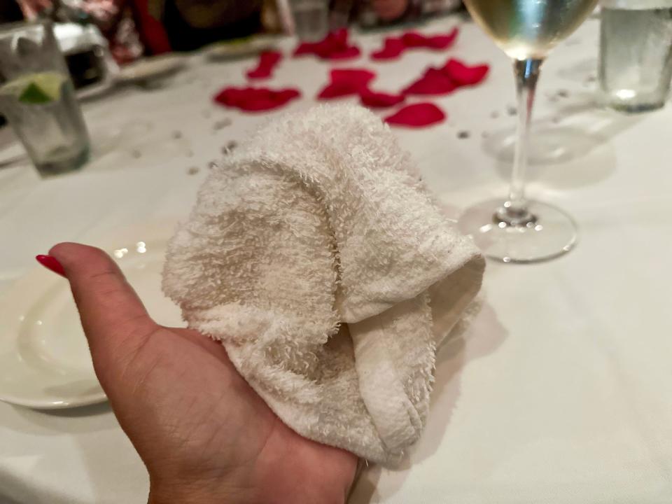 Hand holding warm cloth at  Capital Grille 