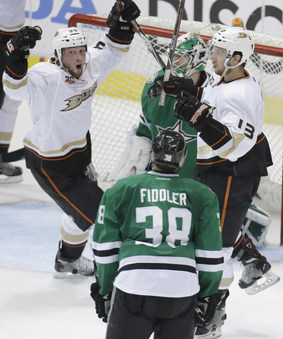 Anaheim Ducks center Nick Bonino (13) celebrates scoring a goal with teammate Matt Beleskey (39) as Dallas Stars goalie Kari Lehtonen (32) and Vernon Fiddler (38) look on during the third period of Game 6 of a first-round NHL hockey playoff series in Dallas, Sunday, April 27, 2014. The Ducks won 5-4 in overtime. (AP Photo/LM Otero)