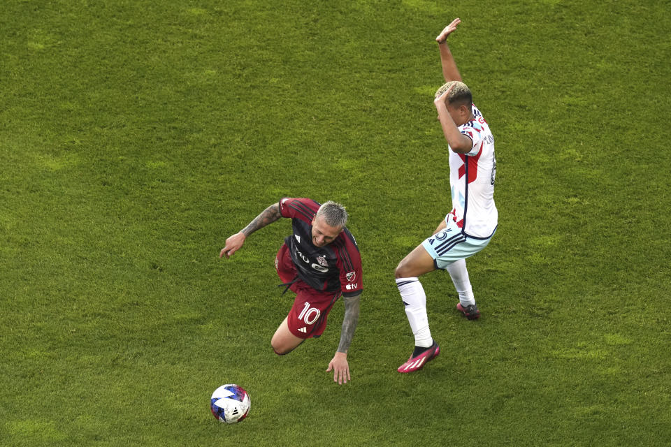 Toronto FC's Federico Bernardeschi, left, is fouled by Chicago Fire's Miguel Angel Navarro during the first half of an MLS soccer match Wednesday, May 31, 2023, in Toronto. (Chris Young/The Canadian Press via AP)