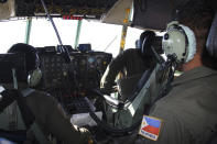 In this photo taken Tuesday, March 11, 2014, Philippine Air Force C-130 crew members continue their search and rescue mission over the South China Sea more than four days after a Malaysia Airlines jetliner went missing en route to Beijing. Authorities acknowledged Wednesday they didn't know which direction the plane carrying 239 passengers was heading when it disappeared, vastly complicating efforts to find it. Several dozen ships and aircraft from some 12 countries are continuing the search for the missing Boeing 777. (AP Photo/Philippine Air Force Western Command)