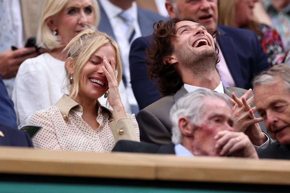 Sienna Miller and husband Oli Green laugh up a storm in the royal box.