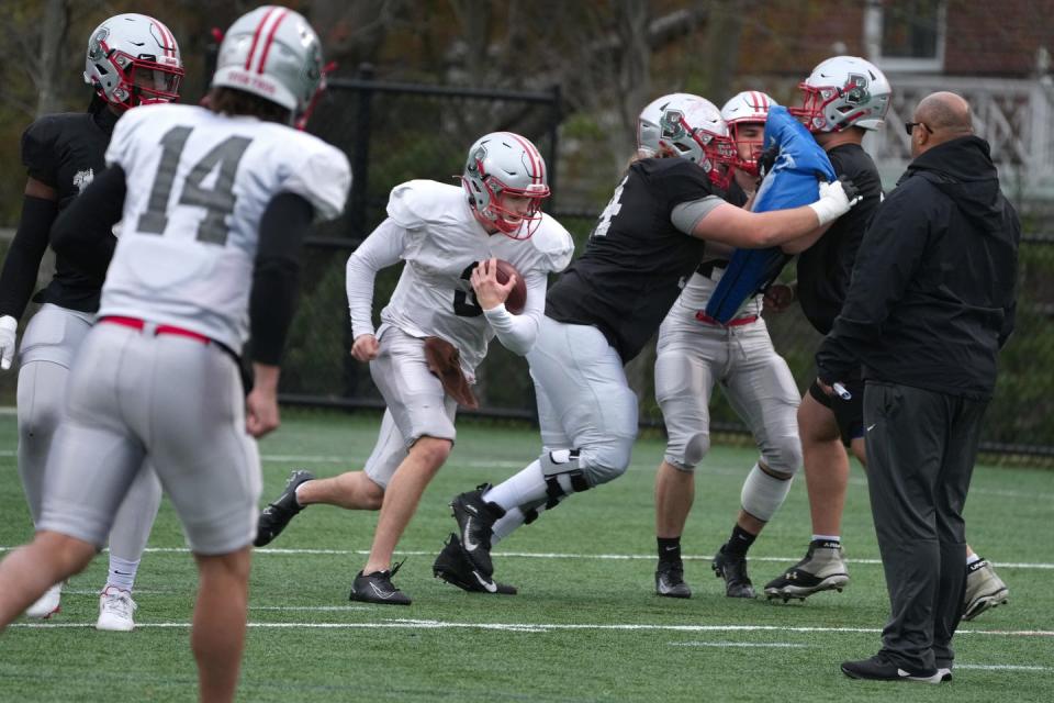 Offensive players run through a drill during Brown University's last day of spring practice.