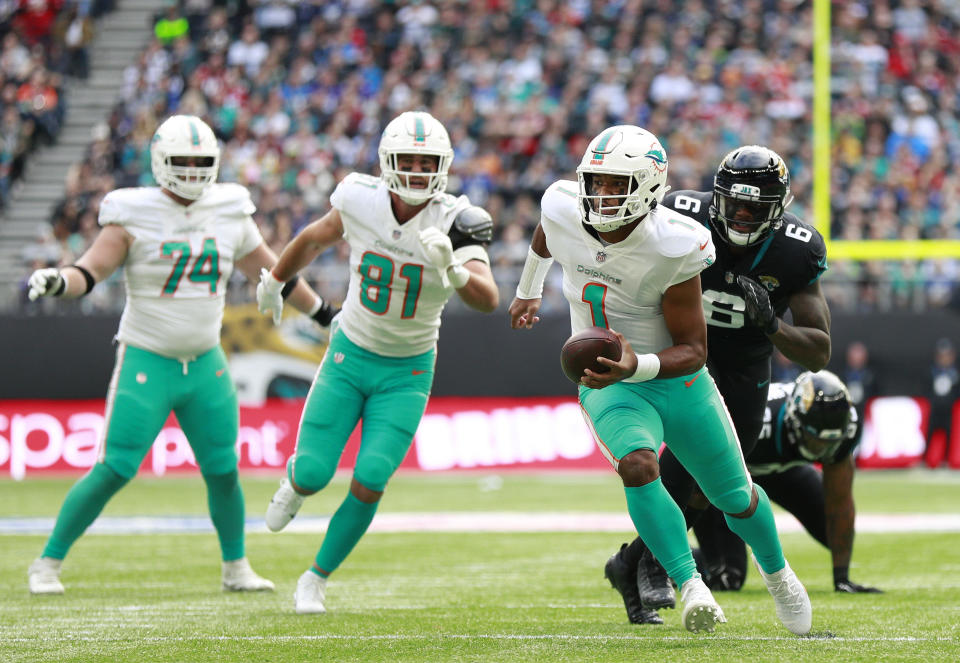 Miami Dolphins quarterback Tua Tagovailoa (1) runs with the ball during an NFL football game between the Miami Dolphins and the Jacksonville Jaguars at the Tottenham Hotspur stadium in London, England, Sunday, Oct. 17, 2021. (AP Photo/Ian Walton)