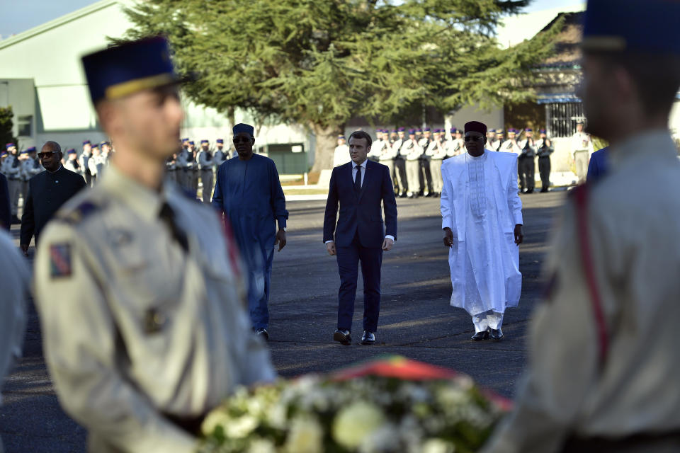 French President Emmanuel Macron arrives to pay tribute to French soldiers who died in Mali helicopter crash, Monday Jan.13, 2020 in Pau, southwestern France. France is preparing its military to better target Islamic extremists in a West African region that has seen a surge of deadly violence. (AP Photo/Alvaro Barrientos, Pool)