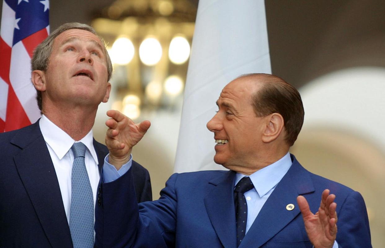 Things looking up for the Bush-Berlusconi relationship. <a href="https://www.gettyimages.com/detail/news-photo/president-george-w-bush-and-italian-prime-minister-silvio-news-photo/119806434?adppopup=true" rel="nofollow noopener" target="_blank" data-ylk="slk:Philippe Desmazes/AFP via Getty Images);elm:context_link;itc:0;sec:content-canvas" class="link ">Philippe Desmazes/AFP via Getty Images)</a>