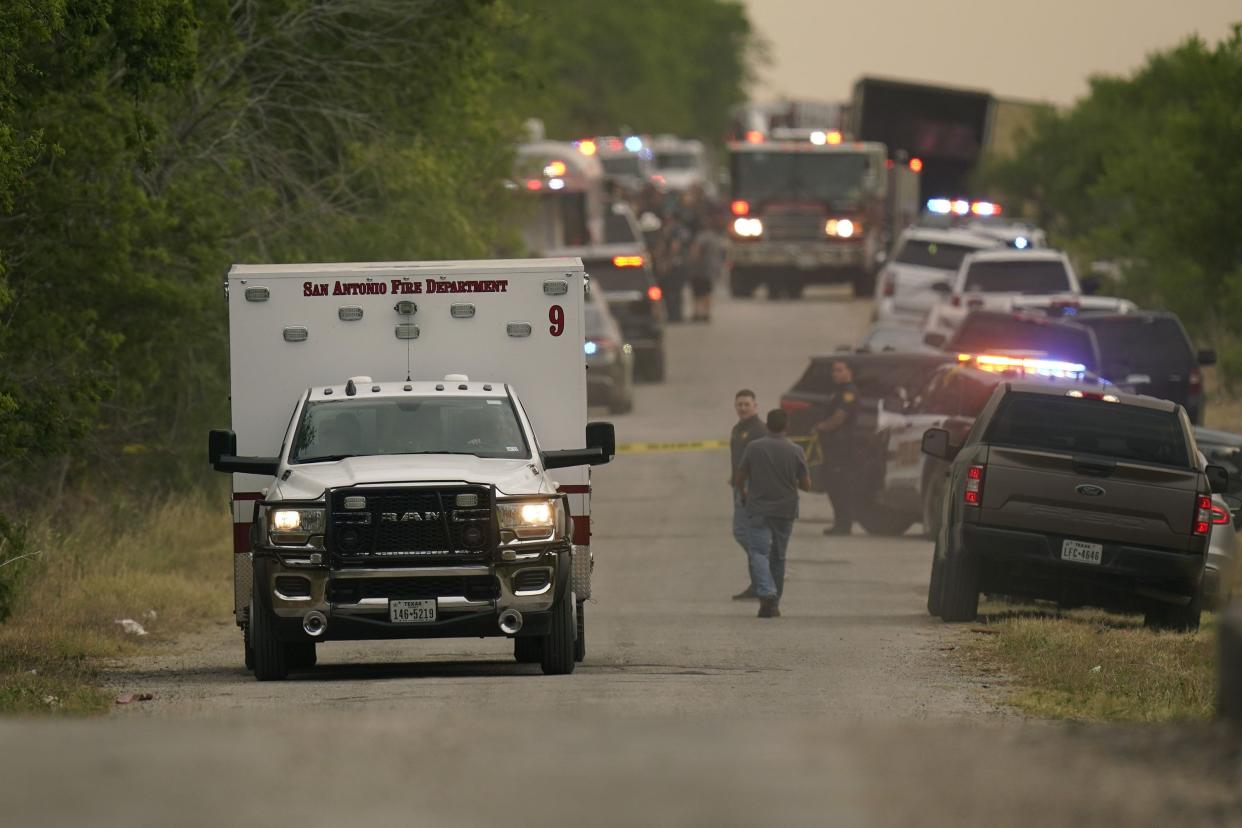 An ambulance leaves the scene where police said dozens of people were found dead in a semitrailer in a remote area in southwestern San Antonio on Monday, June 27, 2022.