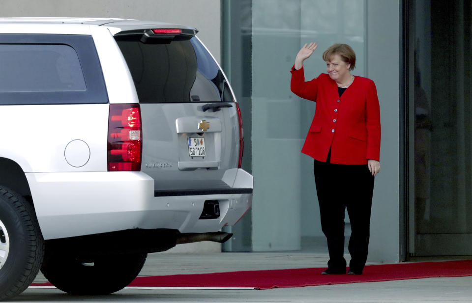 German Chancellor Angela Merkel waves farewell to former US President Barack Obama after a meeting at the chancellery in Berlin, Germany, Friday, April 5, 2019. (AP Photo/Michael Sohn)