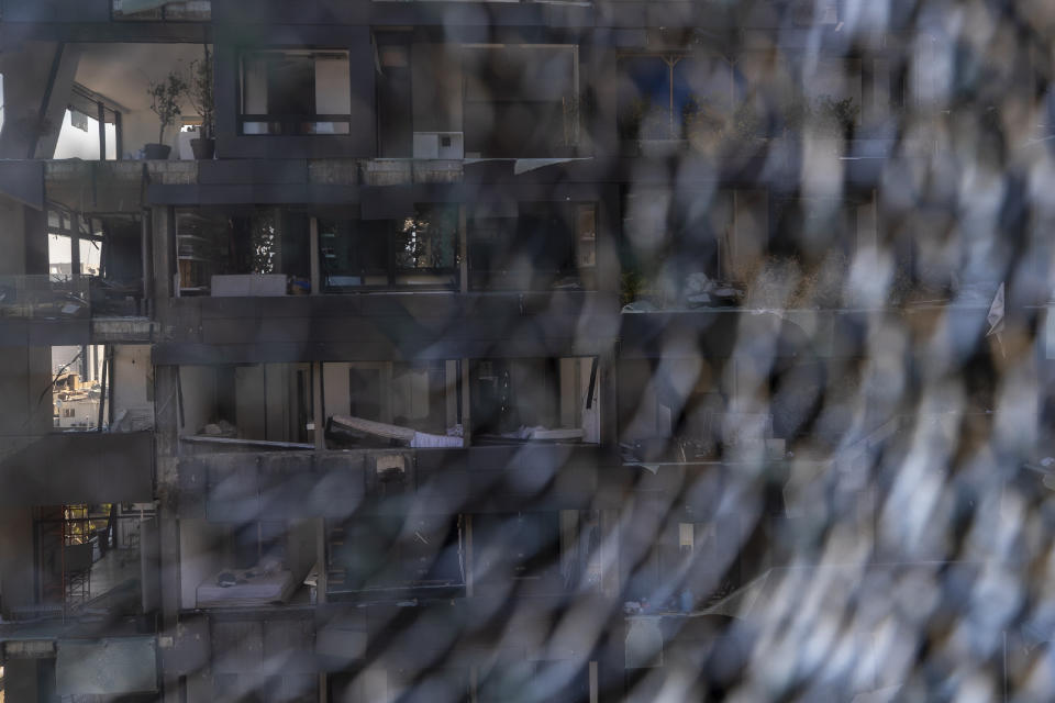 A damaged building is seen through a broken glass near the site of the Aug. 4 explosion that killed more than 170 people, injured thousands and caused widespread destruction, in Beirut, Lebanon, Friday, Aug. 14, 2020. (AP Photo/Hassan Ammar)