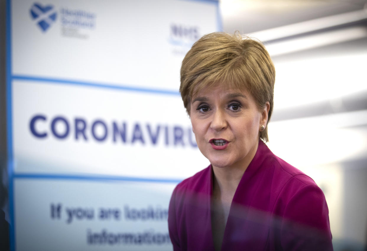 Scotland's First Minister Nicola Sturgeon stands near a sign reading "CORONAVIRUS" as she speaks during a visit to the NHS 24 contact centre at the Golden Jubilee National Hospital in Glasgow, Scotland, on March 4, 2020. - Up to one fifth of employees could be off work in Britain when the coronavirus outbreak peaks, the government said Tuesday outlining a new action plan. Britain had 51 confirmed cases of COVID-19 as of 9:00 am (0900 GMT), an increase of 12 in 24 hours, as Prime Minister Boris Johnson warned the count was "highly likely" to keep rising. (Photo by Jane Barlow / POOL / AFP) (Photo by JANE BARLOW/POOL/AFP via Getty Images)