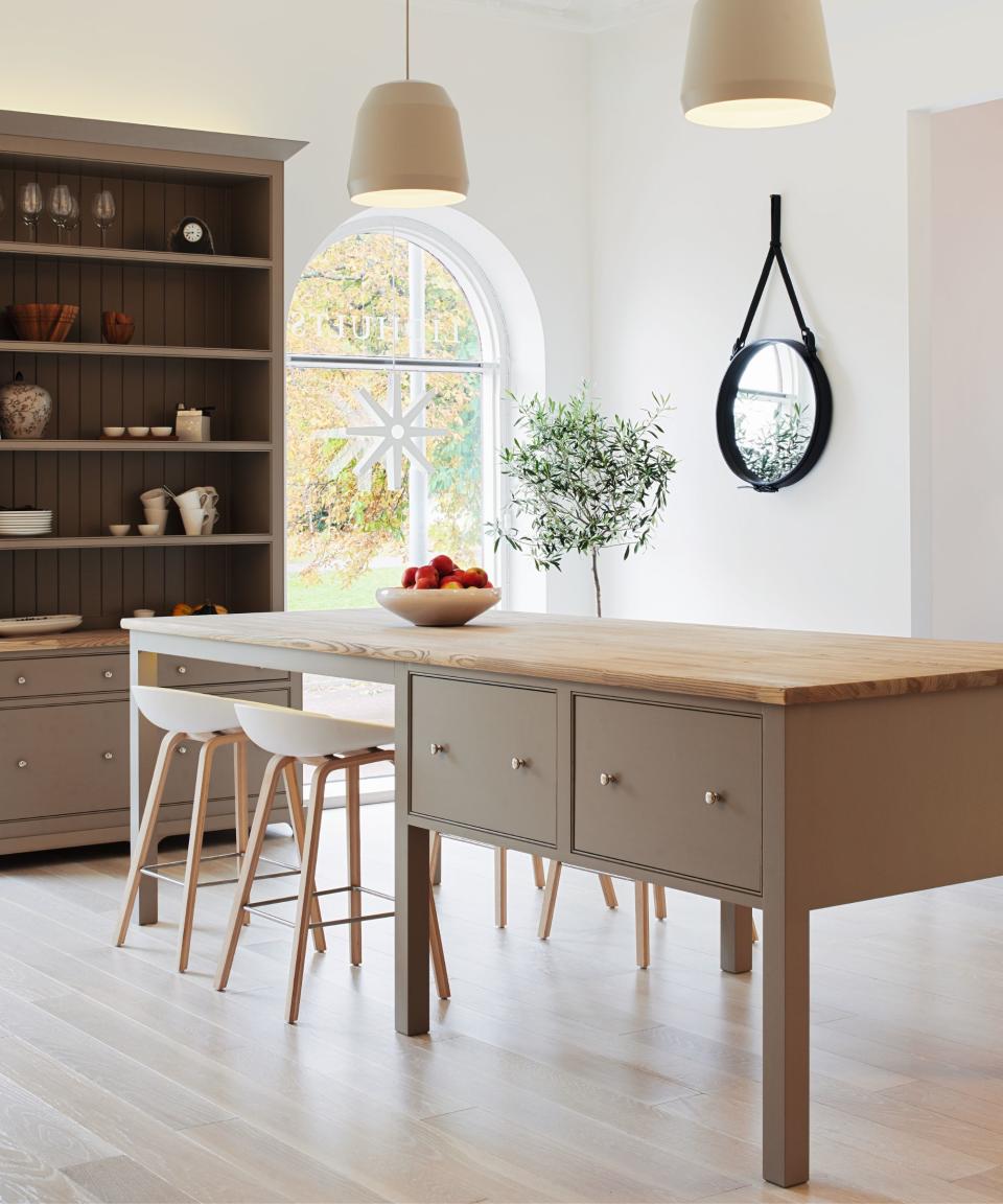 Wooden high table, grey drawers, black framed hanging mirror