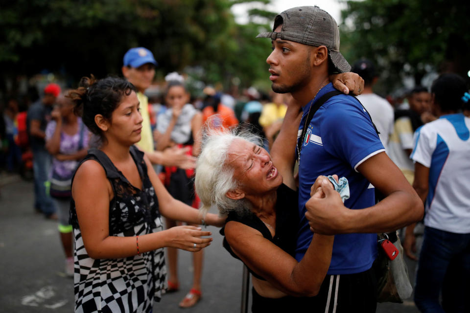 <p>Relatives of inmates held at the General Command of the Carabobo Police react as they wait outside the prison, where a fire occurred in the cells area, according to local media, in Valencia, Venezuela, March 28, 2018. (Photo: Carlos Garcia Rawlins/Reuters) </p>