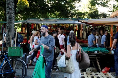 People visit a market in Berlin's Kreuzberg district, Germany, August 19, 2016. Picture taken August 19, 2016. REUTERS/Axel Schmidt