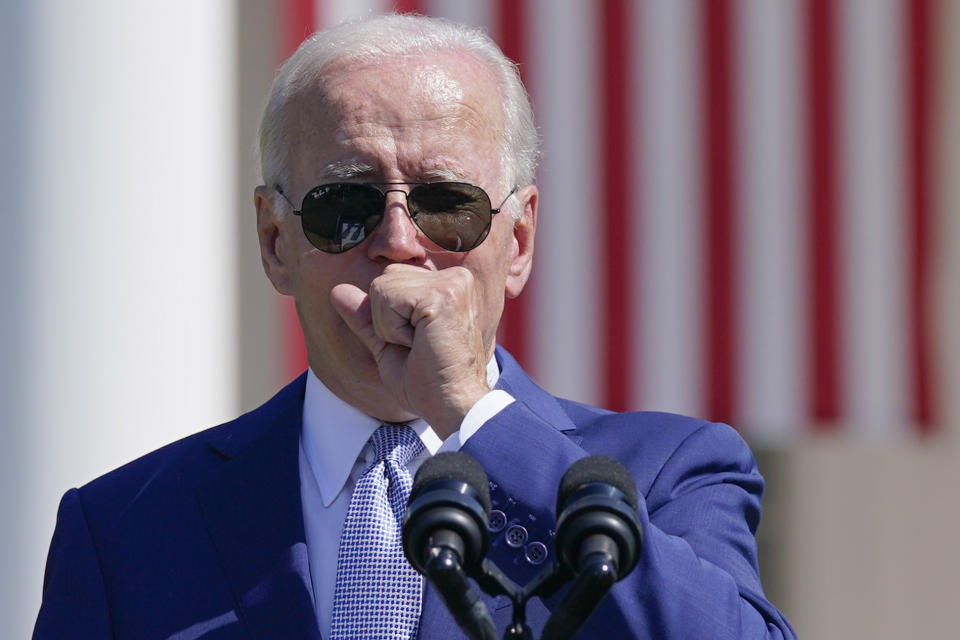 President Joe Biden coughs as he speaks before signing the "CHIPS and Science Act of 2022" during a ceremony on the South Lawn of the White House, Tuesday, Aug. 9, 2022, in Washington. (AP Photo/Evan Vucci)