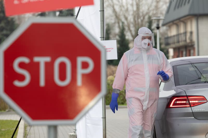 A staff member works at a mobile coronavirus disease (COVID-19) test centre in Warsaw