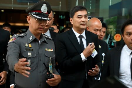 Former Democrat Party leader Abhisit Vejjajiva leaves after announcing his resignation as a member of the parliament in Bangkok