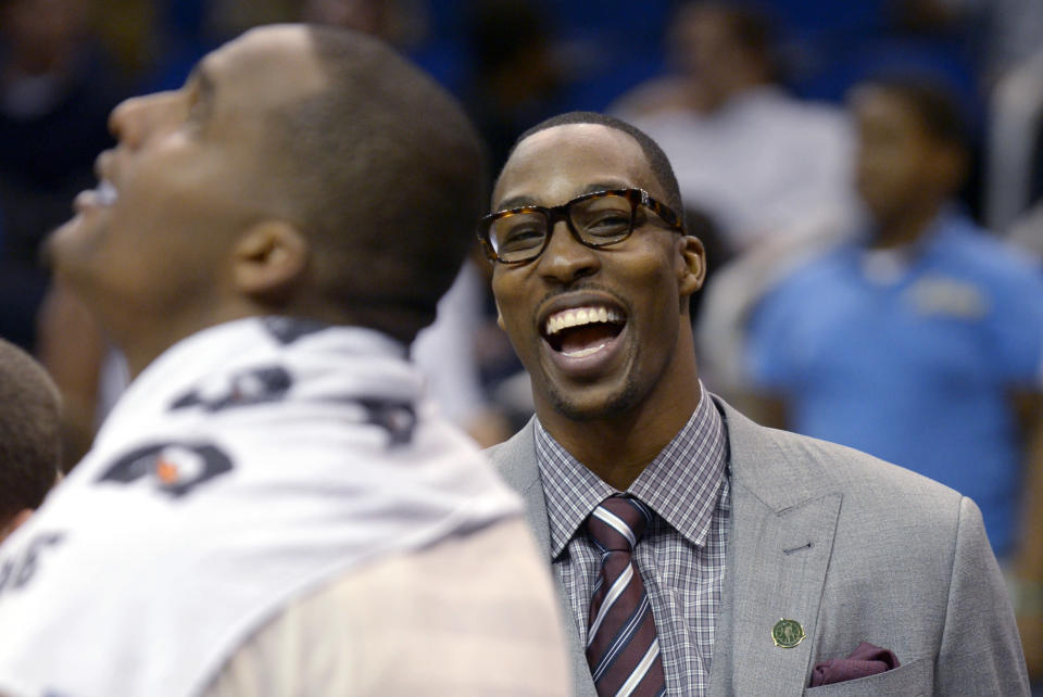 Orlando Magic center Dwight Howard, right, has a laugh with Glen Davis during a timeout near the end of the second half of an NBA basketball game against the Detroit Pistons in Orlando, Fla., Monday, April 9, 2012. The Magic won 119-89. (AP Photo/Phelan M. Ebenhack)