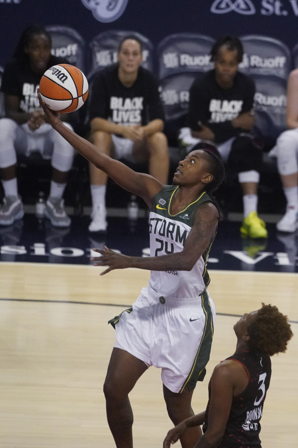 Seattle Storm's Jewell Loyd shoots next to Indiana Fever's Danielle Robinson during the second half of a WNBA basketball game Thursday, June 17, 2021, in Indianapolis. (AP Photo/Darron Cummings)