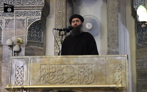 Abu Bakr al-Baghdadi addressing worshippers at a mosque in the northern Iraqi city of Mosul - Credit: AFP