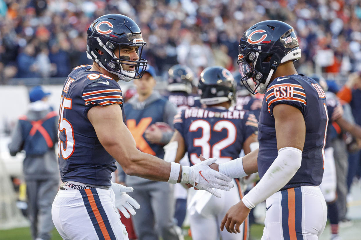 Chicago Bears tight end Cole Kmet (85) and quarterback Justin Fields (1) will be getting some new teammates soon. (AP Photo/Kamil Krzaczynski)