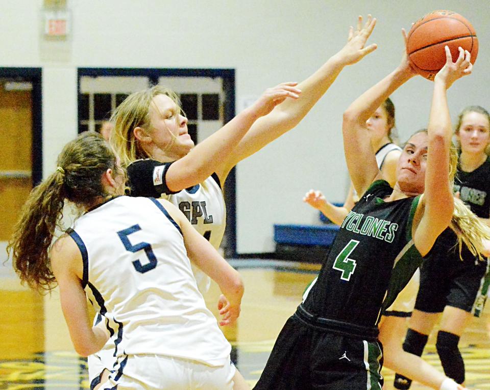 Clark-Willow Lake's Kayla Jordan (4) controls the ball against Great Plains Lutheran's Madeline Prahl and Kim Goens (5) during their high school girls basketball game Monday night in Watertown. Clark-Willow Lake won 45-36.