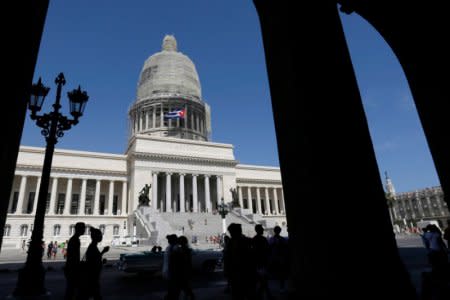 People walk in front of Cuba's Capitol, or El Capitolio, in Havana, Cuba, July 21, 2018. REUTERS/ Stringer