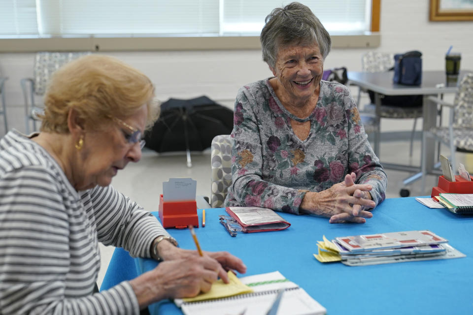 Barbara Steingaszner, 83, of Alexandria, Va., right, and Doris Askin, 84, of Mount Vernon, Va., left, play bridge at Hollin Hall Senior Center in Alexandria, Va., Thursday, Oct. 13, 2022. Millions of Social Security recipients will get an 8.7% boost in their benefits in 2023. (AP Photo/Susan Walsh)