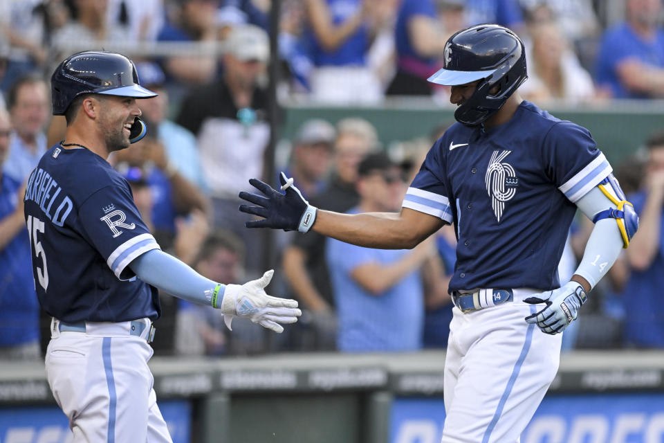 ]Kansas City Royals' Edward Olivares, right, is congratulated by Whit Merrifield after hitting a home run against the Oakland Athletics during the third inning of a baseball game Friday, June 24, 2022, in Kansas City, Mo. (AP Photo/Reed Hoffmann)