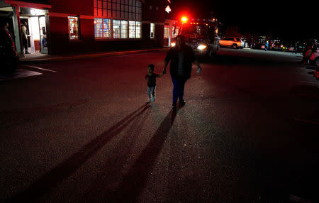 A woman walks past an ambulance near the scene of a shooting at a Walmart in Thornton, Colorado November 1, 2017. REUTERS/Rick Wilking