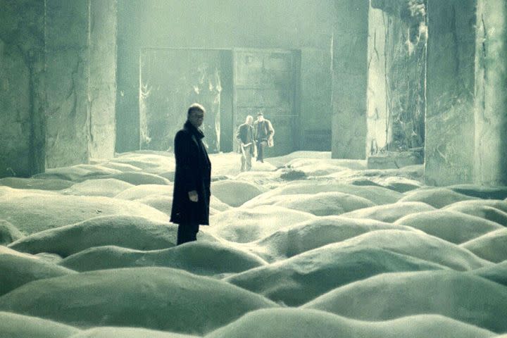 Three men in a room full of white dust in Stalker (1979).