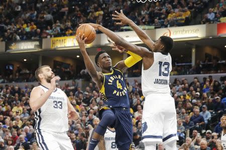 Oct 17, 2018; Indianapolis, IN, USA; Indiana Pacers guard Victor Oladipo (4) takes a shot against Memphis Grizzlies forward Jaren Jackson Jr. (13) during the third quarter at Bankers Life Fieldhouse. Mandatory Credit: Brian Spurlock-USA TODAY Sports