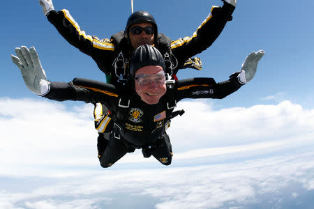 FILE PHOTO: Former U.S. President George H.W. Bush (bottom) celebrates his 85th birthday by jumping with the Army's Golden Knight parachute team in a tandem jump with SFC Michael Elliott in Kennebunkport, Maine in this file handout photo released June 12, 2009. U.S. Army Parachute Team/Handout via REUTERS/File Photo