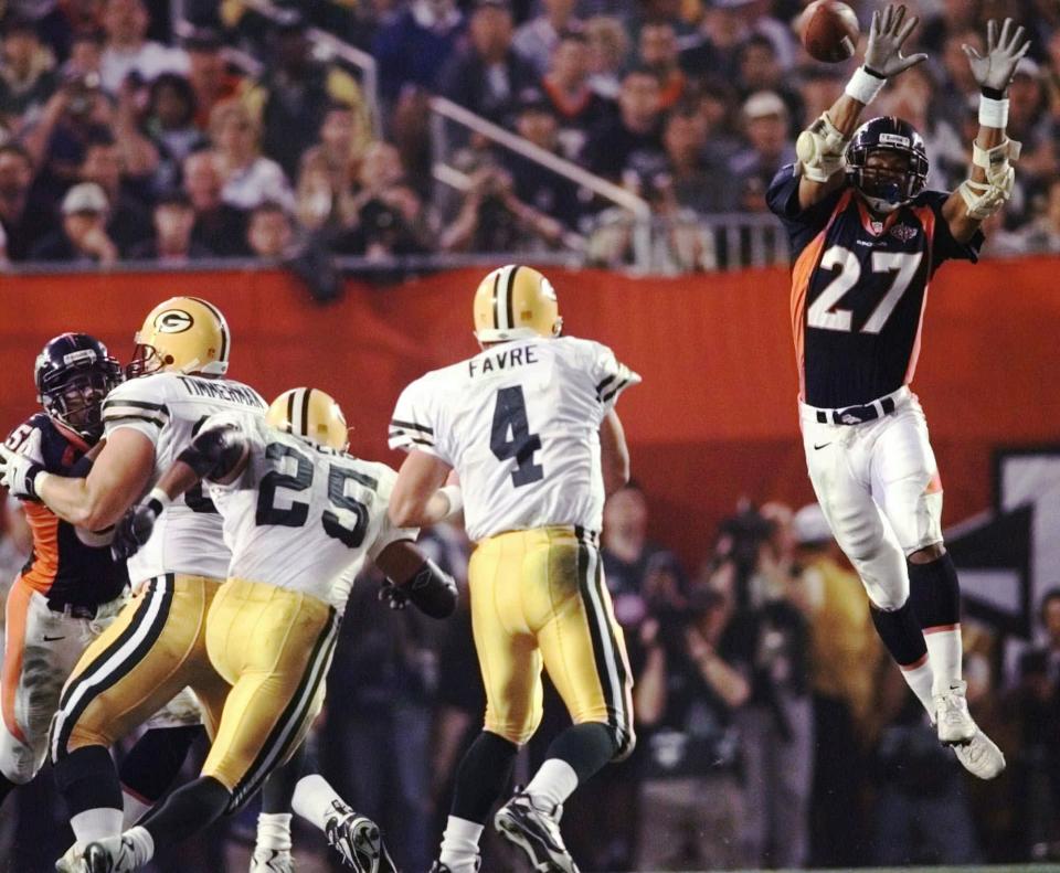 FILE - In this Jan. 25, 1998, file photo, Denver Broncos safety Steve Atwater (27) jumps into the air in an attempt to block a pass by Green Bay Packers quarterback Brett Favre during the third quarter of NFL football's Super Bowl 32 at San Diego's Qualcomm Stadium. At left are Packers' Dorsey Levens (25) and Adam Timmerman (63). Atwater is part of the 2020 class to be inducted into the Pro Football Hall of Fame. (AP Photo/John Gaps III, File)