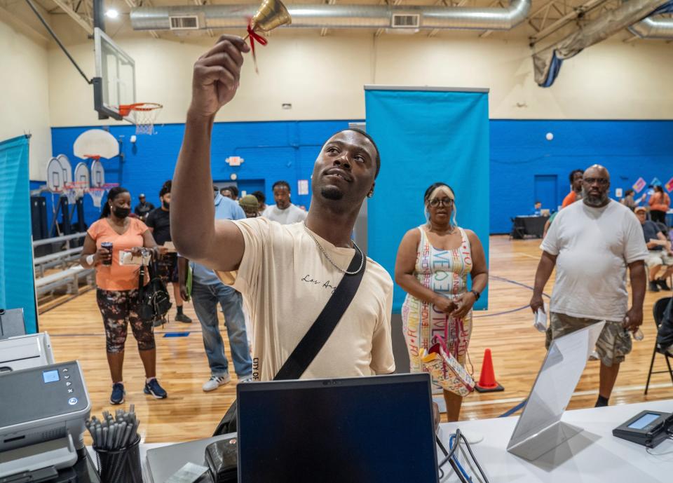 DeVante Amos, 24, of Detroit, rings a bell after passing his test to get his driver's permit during the Road to Restoration program clinic held at LA SED Senior and Youth Center in southwest Detroit on Tuesday, June 18, 2024. 