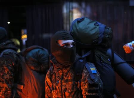 A new volunteer for the Ukrainian Interior Ministry's Azov battalion is pictured before he depart to the frontlines in eastern Ukraine, in central Kiev January 17, 2015. REUTERS/Gleb Garanich