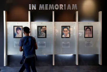 A student looks at the portraits of four students who were killed during the political turmoil of 1998 at a small museum dedicated to them inside Trisakti University in Jakarta, Indonesia, May 9, 2018. REUTERS/Willy Kurniawan